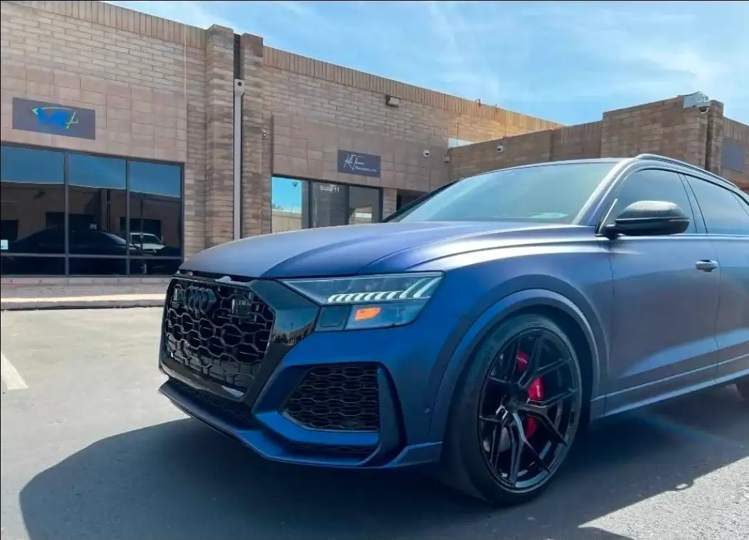 Front three-quarter view of a blue Audi RS Q8 with tinted windows at the Tempe shop