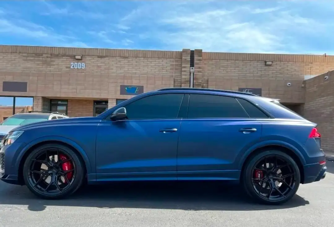 Blue Audi RS Q8 with dark ceramic window tint parked outside the Mr. Glassworks Tempe shop