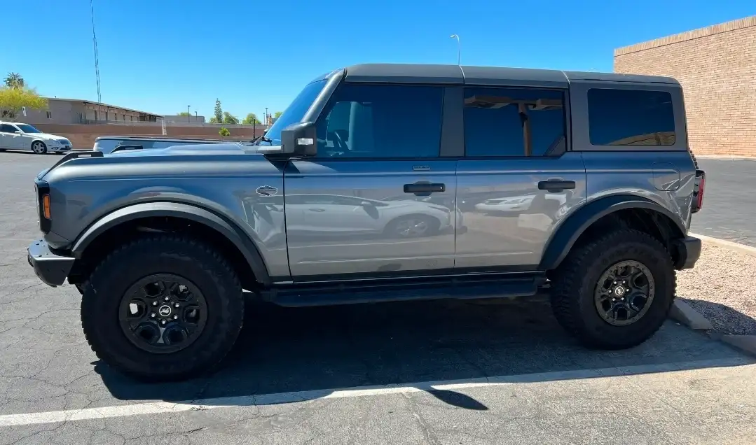 Gray Ford Bronco 4-door with dark tinted windows parked at the Mr. Glassworks Tempe shop area