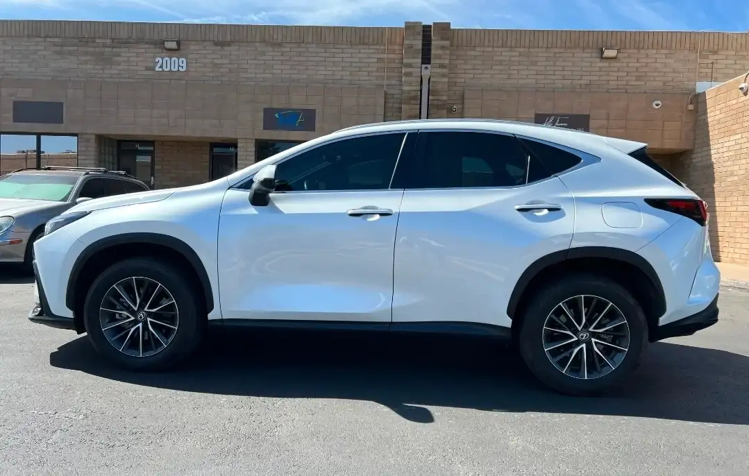 White Lexus NX compact SUV with dark tinted windows parked outside the Tempe shop