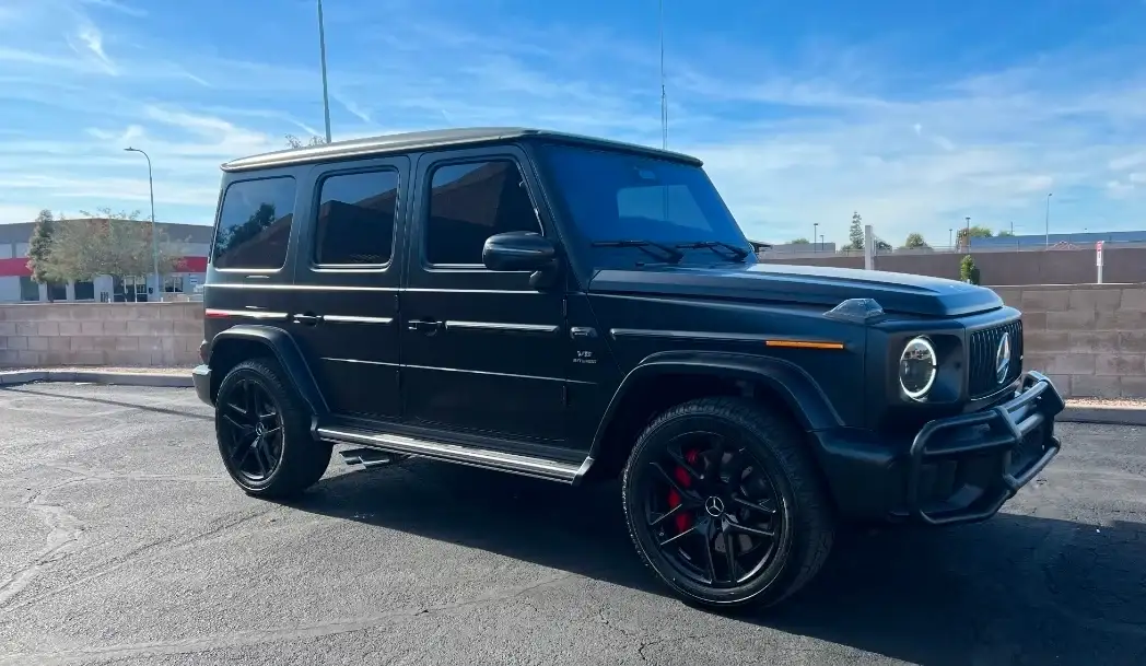 Black Mercedes-Benz G63 AMG with dark tinted windows and red brake calipers