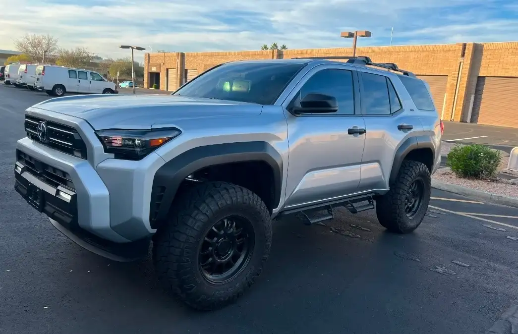Silver Toyota 4Runner with dark tinted windows and off-road tires at the Tempe shop