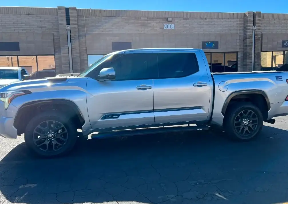 Silver Toyota Tacoma Platinum crew cab with tinted windows at the Tempe shop location