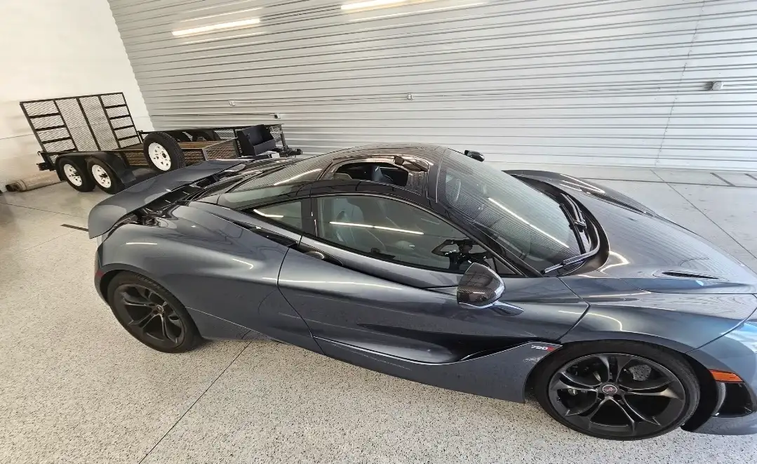 Gray McLaren 720S supercar inside the Mr. Glassworks shop after windshield replacement