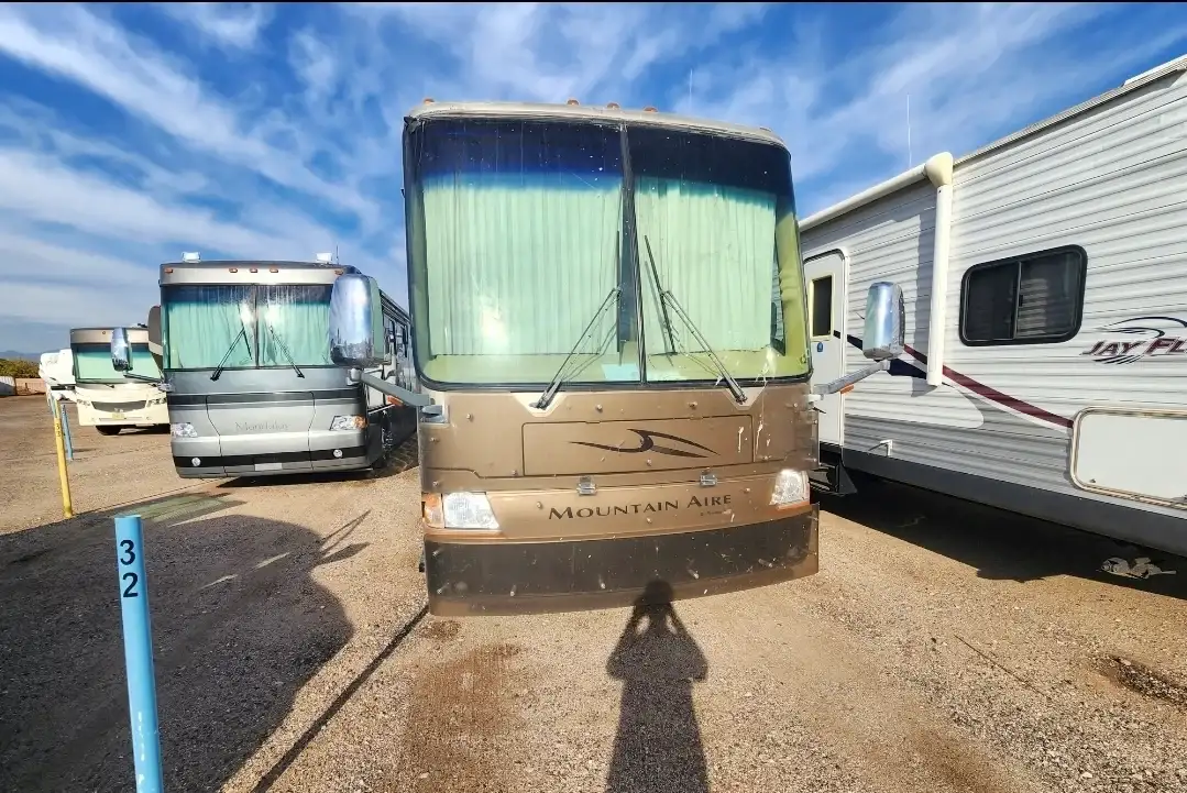 Newmar Mountain Aire Class A diesel pusher motorhome at an RV storage lot showing large two-piece windshield